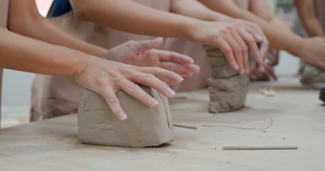 Hands Kneading Clay at Pottery Workshop
